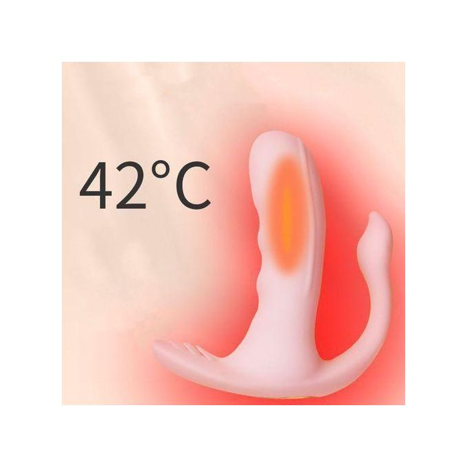 Pink handheld massager on a soft surface with a warm glow